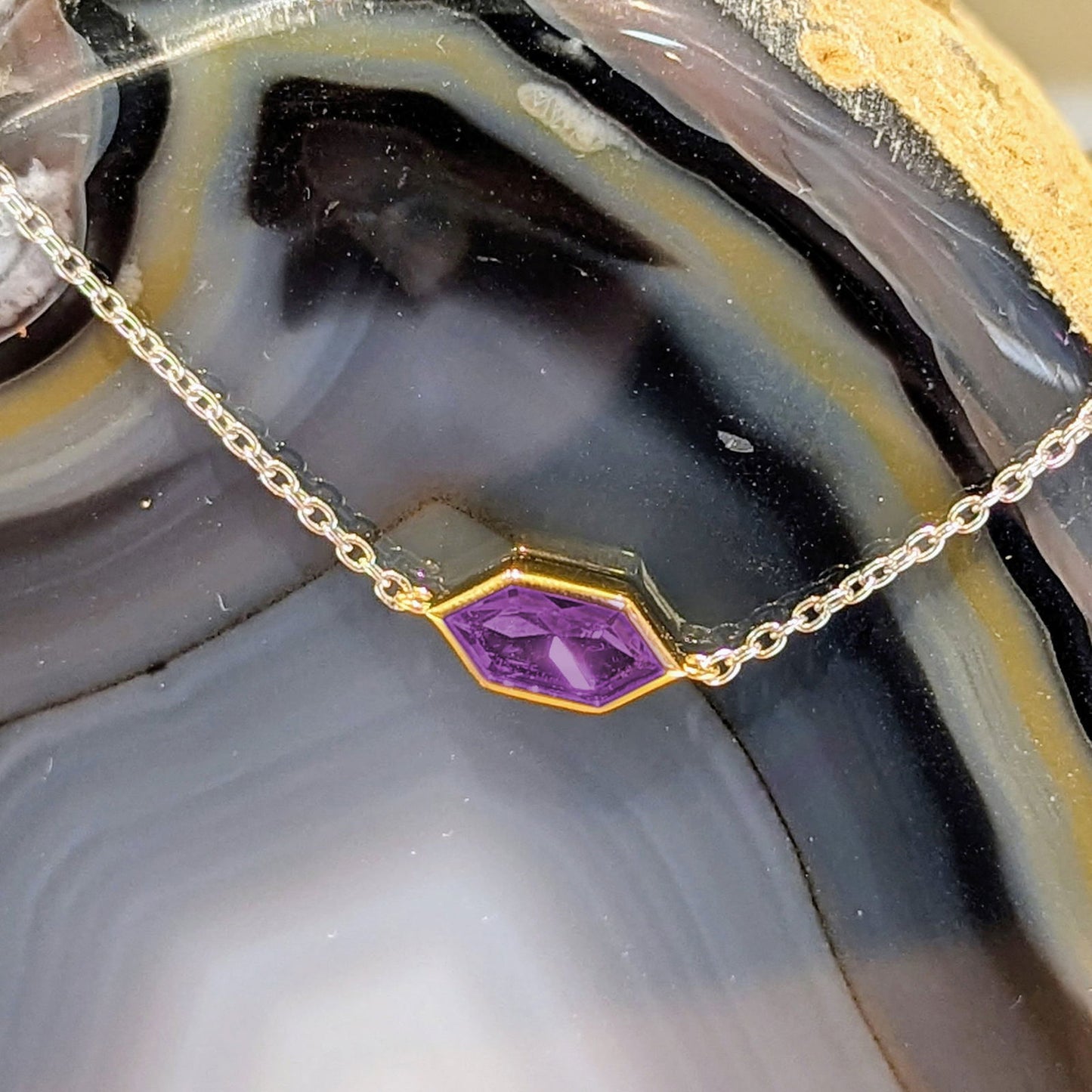 Photo of Yellow gold Plate Accented CZ Hexagon Bracelet in a decorative scene, designed by , available at Plumb Gold & Plumb Silver