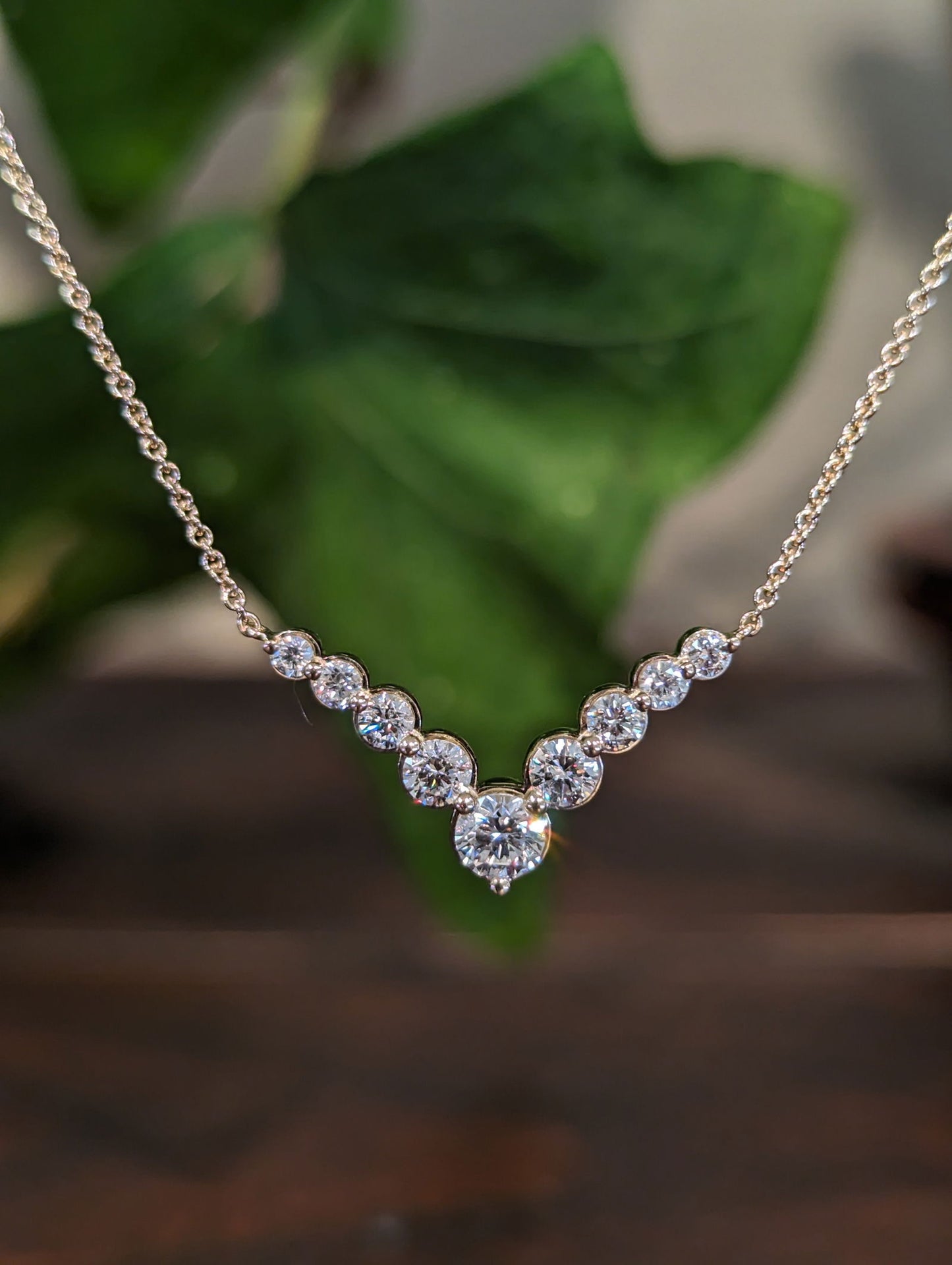 Photo of Zeghani Diamond "V" Necklace in a decorative scene, designed by , available at Plumb Gold & Plumb Silver