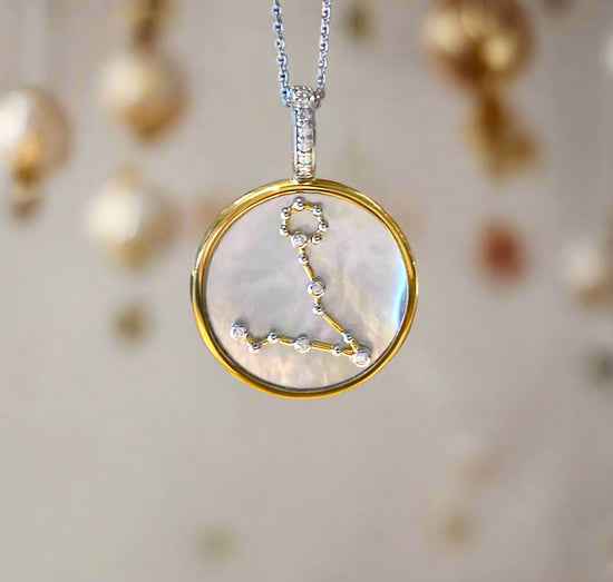 Photo of Zodiac Pendant in a decorative scene, designed by , available at Plumb Gold & Plumb Silver