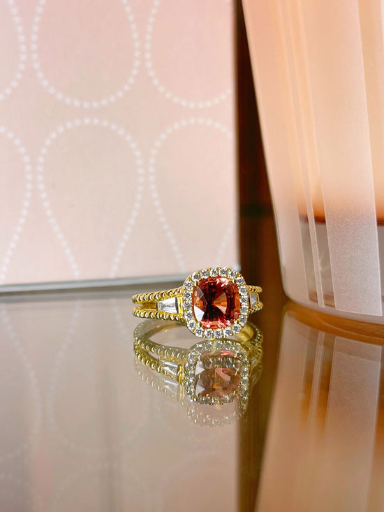 Photo of Zoma Color Peach Spinel Ring in a decorative scene, designed by , available at Plumb Gold & Plumb Silver