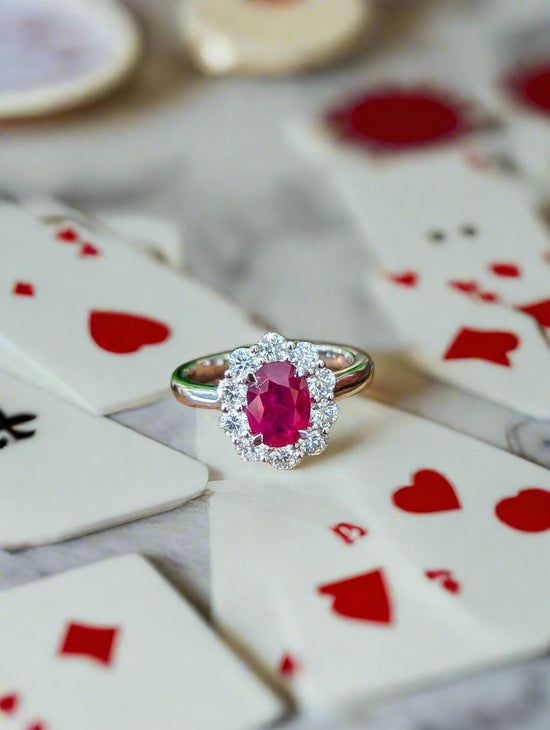 Photo of Zoma Color Ruby Halo Ring in a decorative scene, designed by , available at Plumb Gold & Plumb Silver